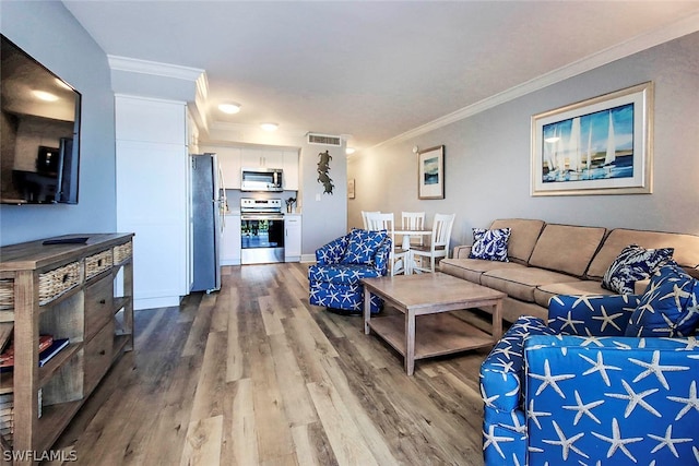 living room with hardwood / wood-style floors and ornamental molding