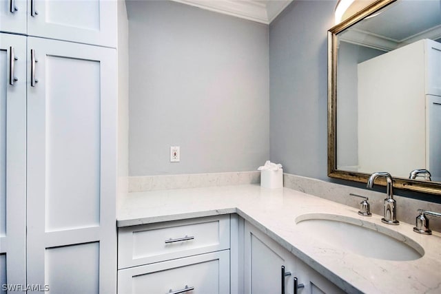 bathroom with vanity and ornamental molding