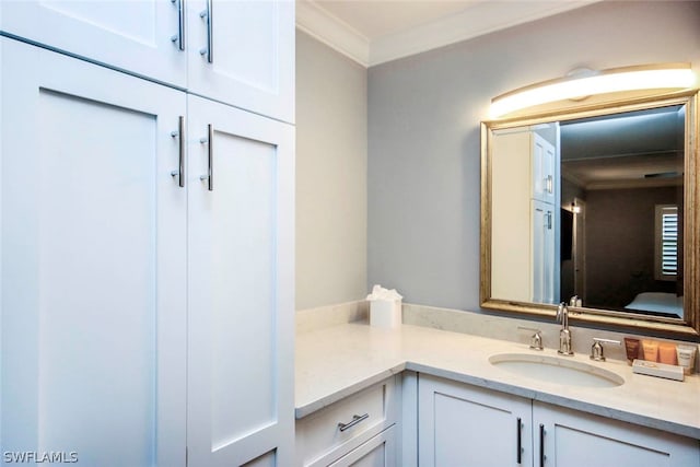 bathroom featuring crown molding and vanity