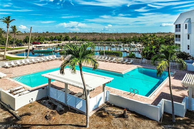 pool featuring fence and a water view