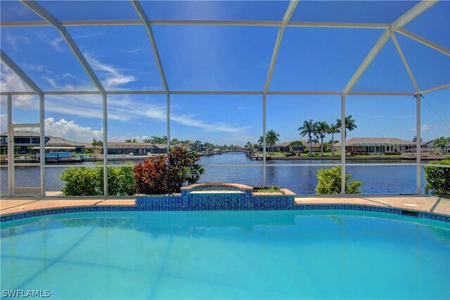 view of pool with an in ground hot tub and a lanai