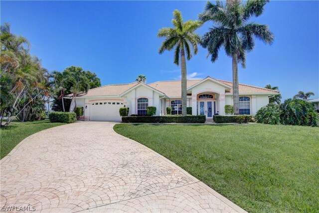 view of front of home featuring a garage and a front lawn