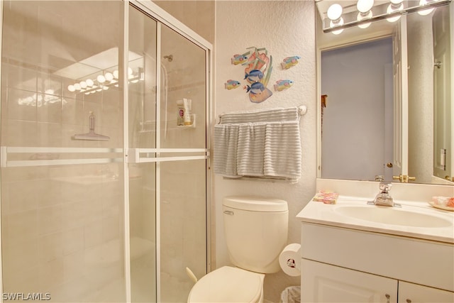 bathroom featuring walk in shower, toilet, and vanity