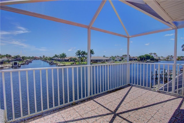 view of patio / terrace with a balcony and a water view