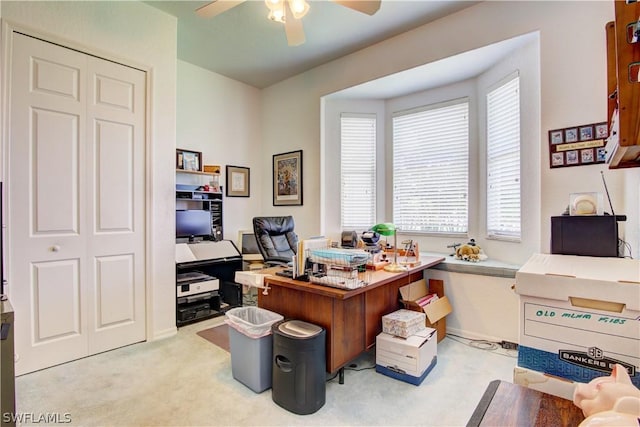 carpeted office space with ceiling fan