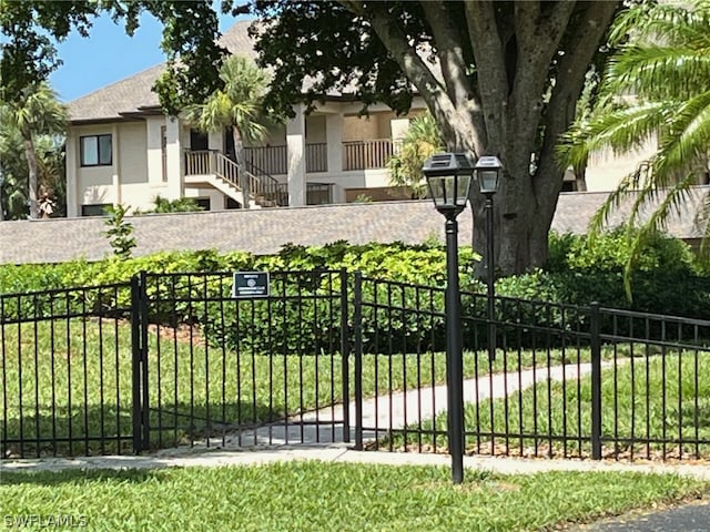 view of gate featuring a yard