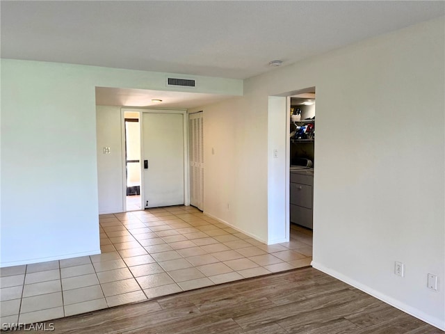 unfurnished bedroom featuring light hardwood / wood-style flooring and a closet