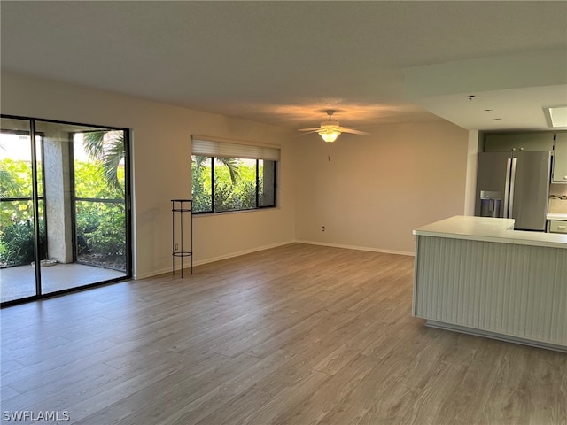 unfurnished room with hardwood / wood-style floors and ceiling fan