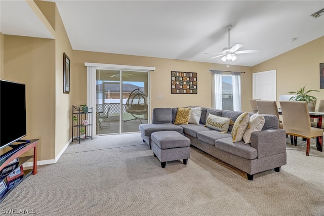 living room with a wealth of natural light, light colored carpet, lofted ceiling, and ceiling fan