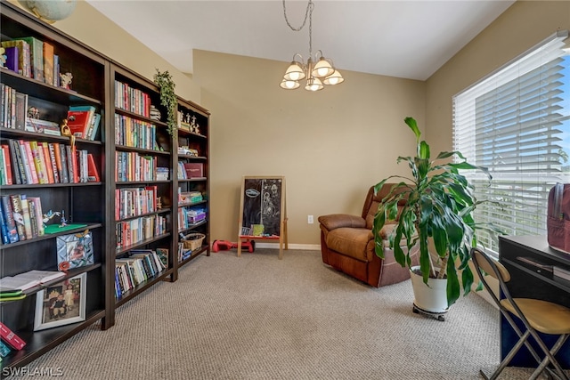 living area featuring light colored carpet and an inviting chandelier