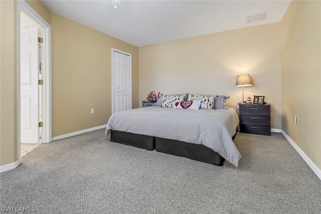 bedroom with a closet and light colored carpet