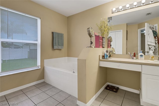 bathroom featuring tiled tub, tile patterned floors, and vanity