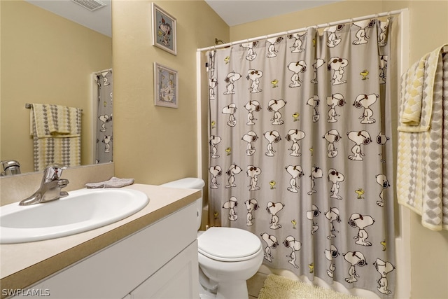 bathroom featuring toilet and vanity