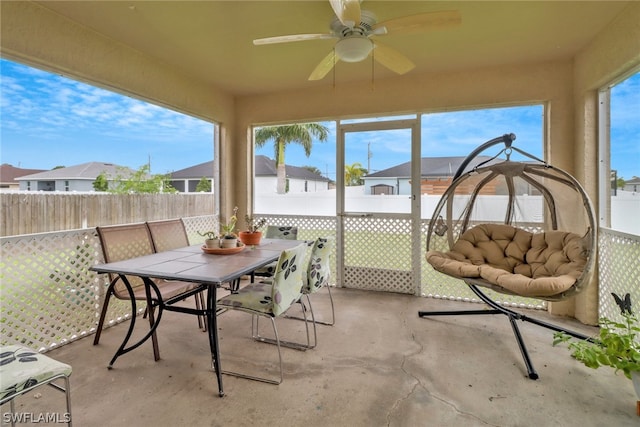 sunroom featuring ceiling fan