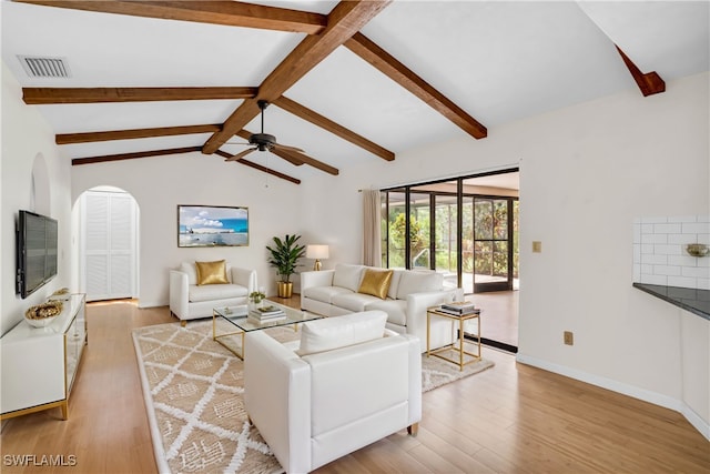 living room with light wood-type flooring, ceiling fan, and vaulted ceiling with beams