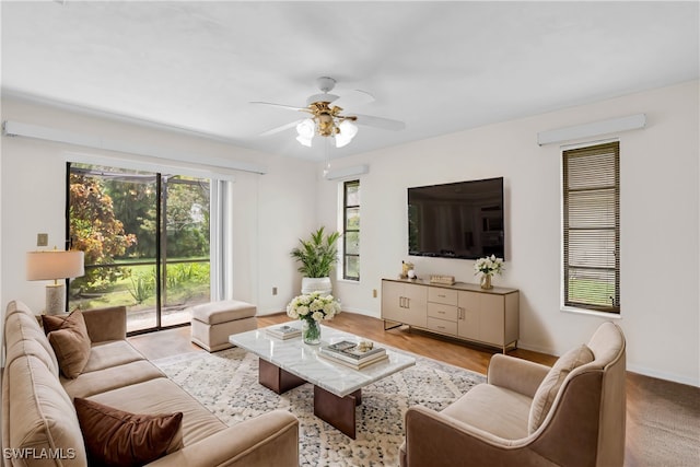 living room featuring light hardwood / wood-style floors and ceiling fan