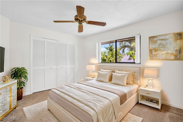 carpeted bedroom with a closet and ceiling fan