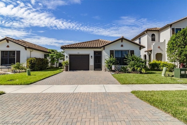 mediterranean / spanish house with a garage and a front lawn