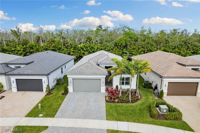 view of front of home with a front yard and a garage