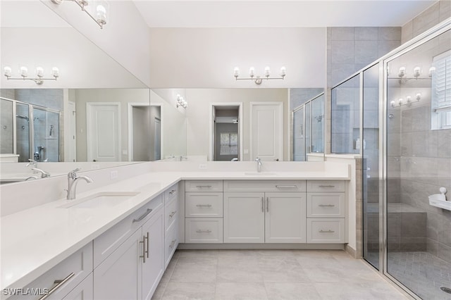 bathroom featuring tile patterned floors, vanity, and an enclosed shower