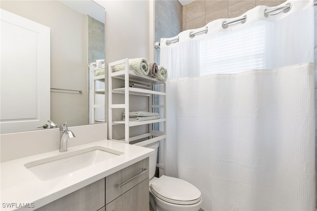 bathroom featuring vanity and toilet