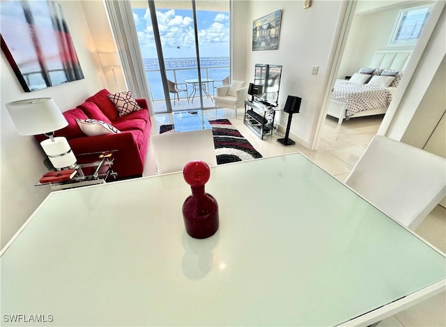 3000 Oasis Grand Blvd Unit 1606, Fort Myers, FL 33916 - living room featuring baseboards and tile patterned flooring