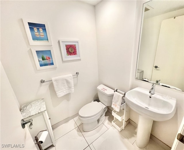 bathroom with tile patterned floors and toilet