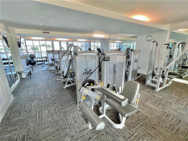 workout area featuring dark carpet