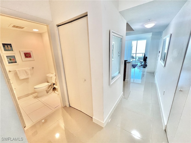 corridor with light tile patterned floors