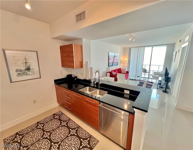 kitchen featuring sink, dishwasher, light tile patterned flooring, and kitchen peninsula