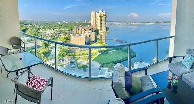 balcony with an outdoor hangout area and a water view