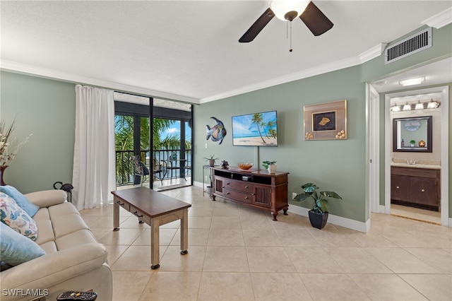 living room with ornamental molding, light tile patterned floors, and ceiling fan