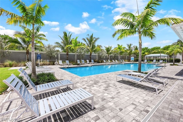 pool featuring a patio and fence