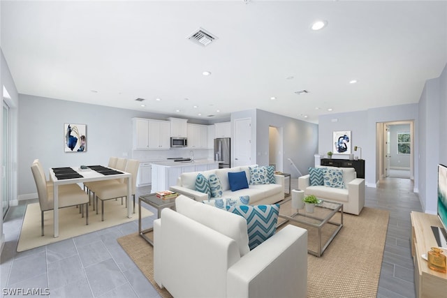 living room with recessed lighting, visible vents, baseboards, and light tile patterned floors