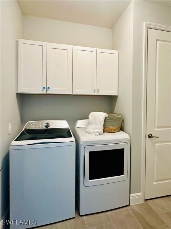 washroom with independent washer and dryer and cabinet space