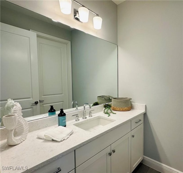 bathroom with vanity and baseboards