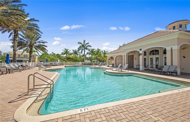 view of pool with french doors and a patio