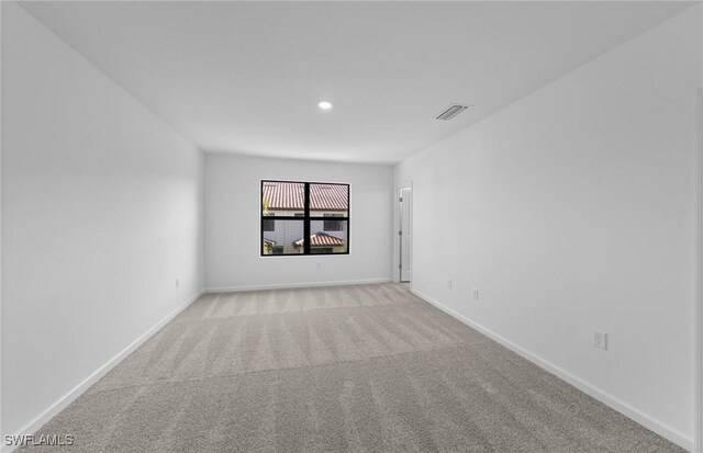 unfurnished room with light colored carpet