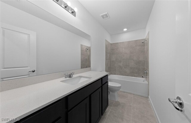 full bathroom with tiled shower / bath combo, vanity, toilet, and tile patterned flooring