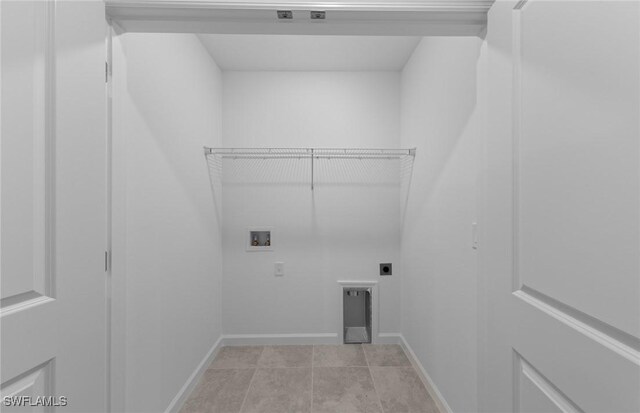 washroom featuring hookup for a washing machine, light tile patterned floors, and electric dryer hookup