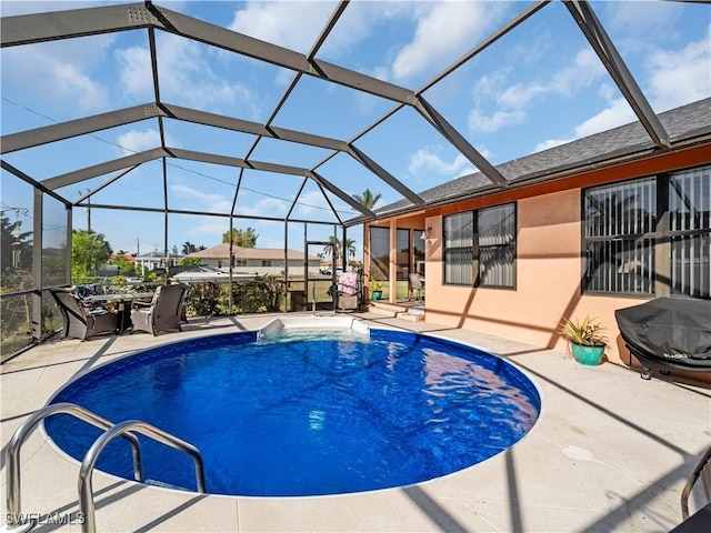 view of swimming pool with glass enclosure and a patio