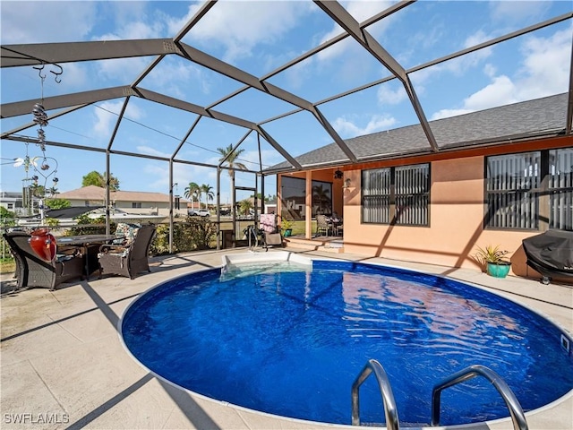 view of swimming pool with a lanai and a patio