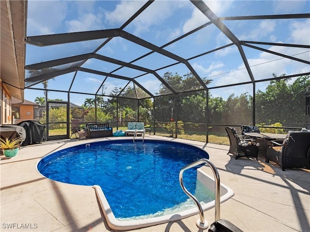 view of swimming pool with glass enclosure, a patio, and grilling area