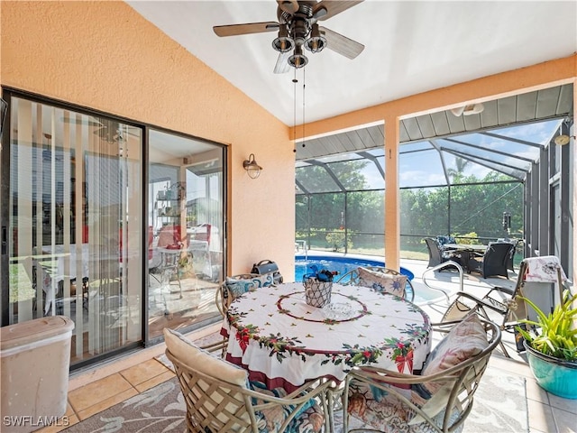 sunroom / solarium with ceiling fan and vaulted ceiling