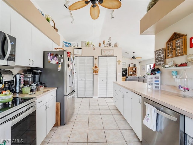 kitchen featuring white cabinets, ceiling fan, light tile patterned floors, and appliances with stainless steel finishes