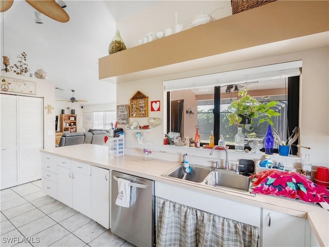 kitchen with ceiling fan, dishwasher, sink, light tile patterned floors, and white cabinets