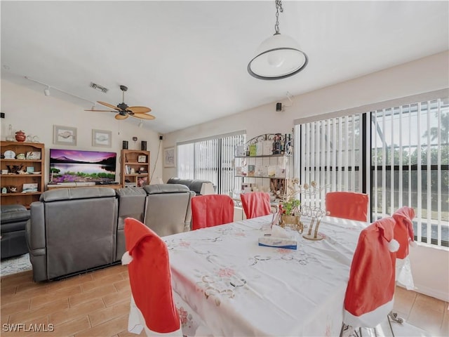 dining room with ceiling fan and lofted ceiling