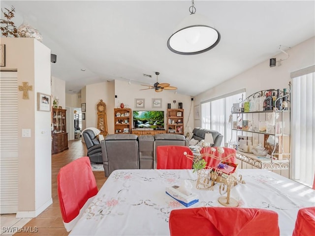 dining area featuring vaulted ceiling and ceiling fan