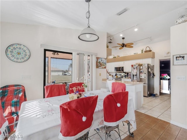 dining room with light tile patterned floors, track lighting, and ceiling fan