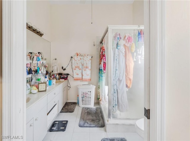 bathroom with tile patterned flooring, vanity, and curtained shower